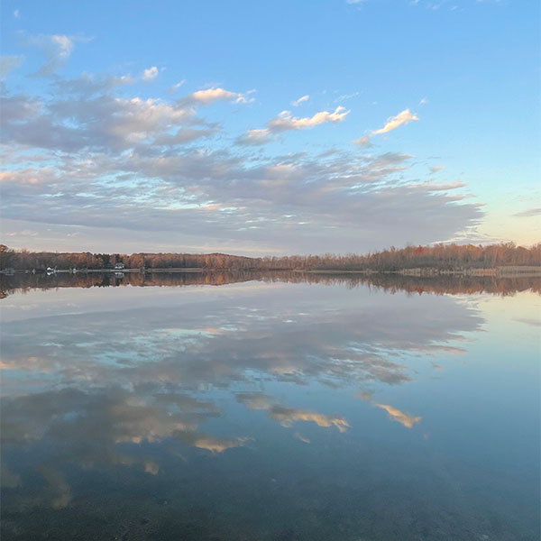 photo of the lake with the sky reflected on the water